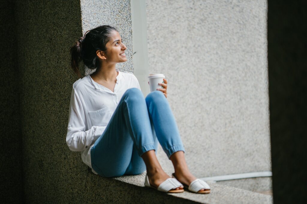 Happy woman drinking a cup of coffee.